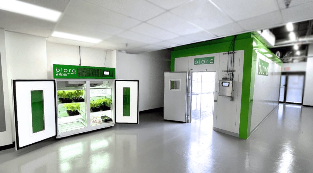 A reach-in plant growth chamber next to a walk-in plant growth chamber.